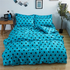 Parure de lit turquoise imprimé coeurs, bonne qualité et à la mode sur un lit dans une maison