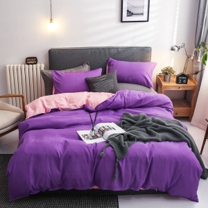 Parure de lit bicolore violette-rose, bonne qualité et très confortable sur un lit dans une maison