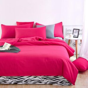 Parure de lit rose cerise à motif zèbre. Bonne qualité, confortable et à la mode sur un lit dans une maison