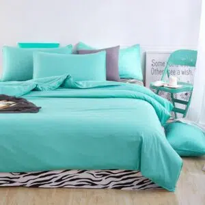 Parure de lit bleu turquoise motif zèbre. Bonne qualité, confortable et à la mode sur un lit dans une maison