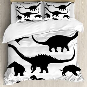 Dans une chambre le lit est décoré d'une parure avec des motifs de dinosaures noirs sur fonds blancs, les coussins sont assortis, la couette est en partie rabattue