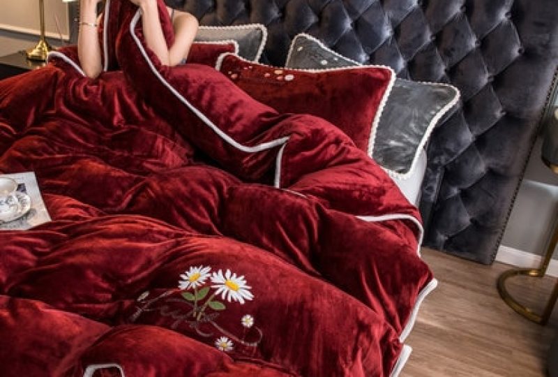 Parure de lit rouge contour blanc. Bonne qualité, confortable et à la mode sur un lit dans une maison