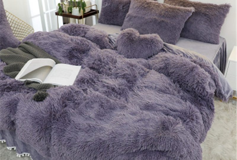 Parure de lit grise effet fourrure. Bonne qualité, confortable et à la mode sur un lit dans une maison