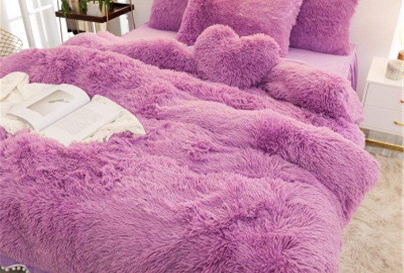 Parure de lit rouge cerise effet fourrure. Bonne qualité, confortable et à la mode sur un lit dans une maison