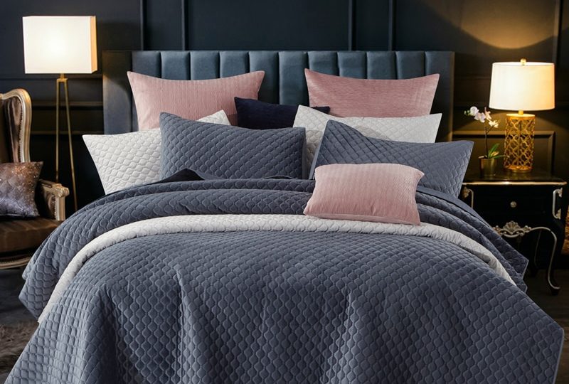 Parure de lit bleu marine à motifs géométriques en relief. Bonne qualité, confortable et à la mode sur un lit dans une maison