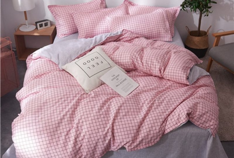 53974-839dc0.jpg Parure de lit rose à motifs carreaux noirs. Bonne qualité, confortable et à la mode sur un lit dans une maison