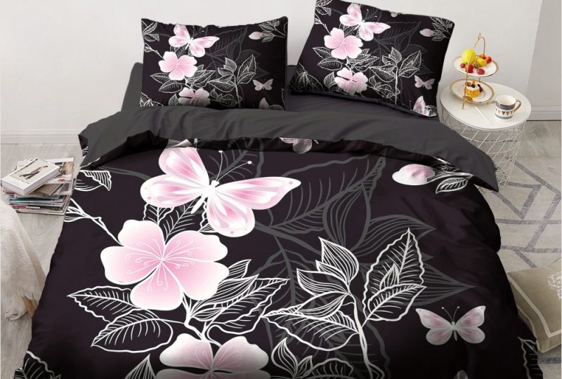 Parure de lit noire à motif fleurs et papillons roses. Bonne qualité, confortable et à la mode sur un lit dans une maison